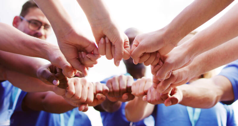 Volunteer Team Joining Hands Together